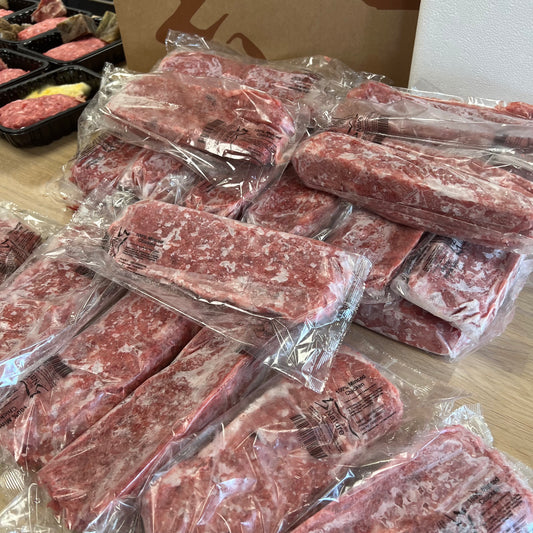 packets of minced food frozen with meal prep in the background Raw dog food from Nurturing by Nature